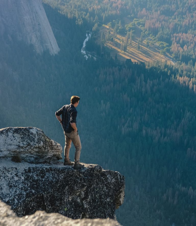 man at top of mountain